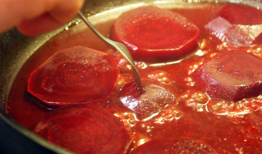 red beets cooking in a pan with bouillon