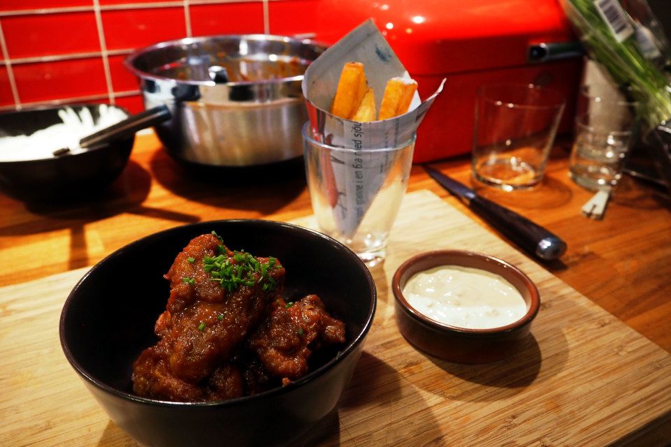 Orange barbecue chicken wings with homemade fries