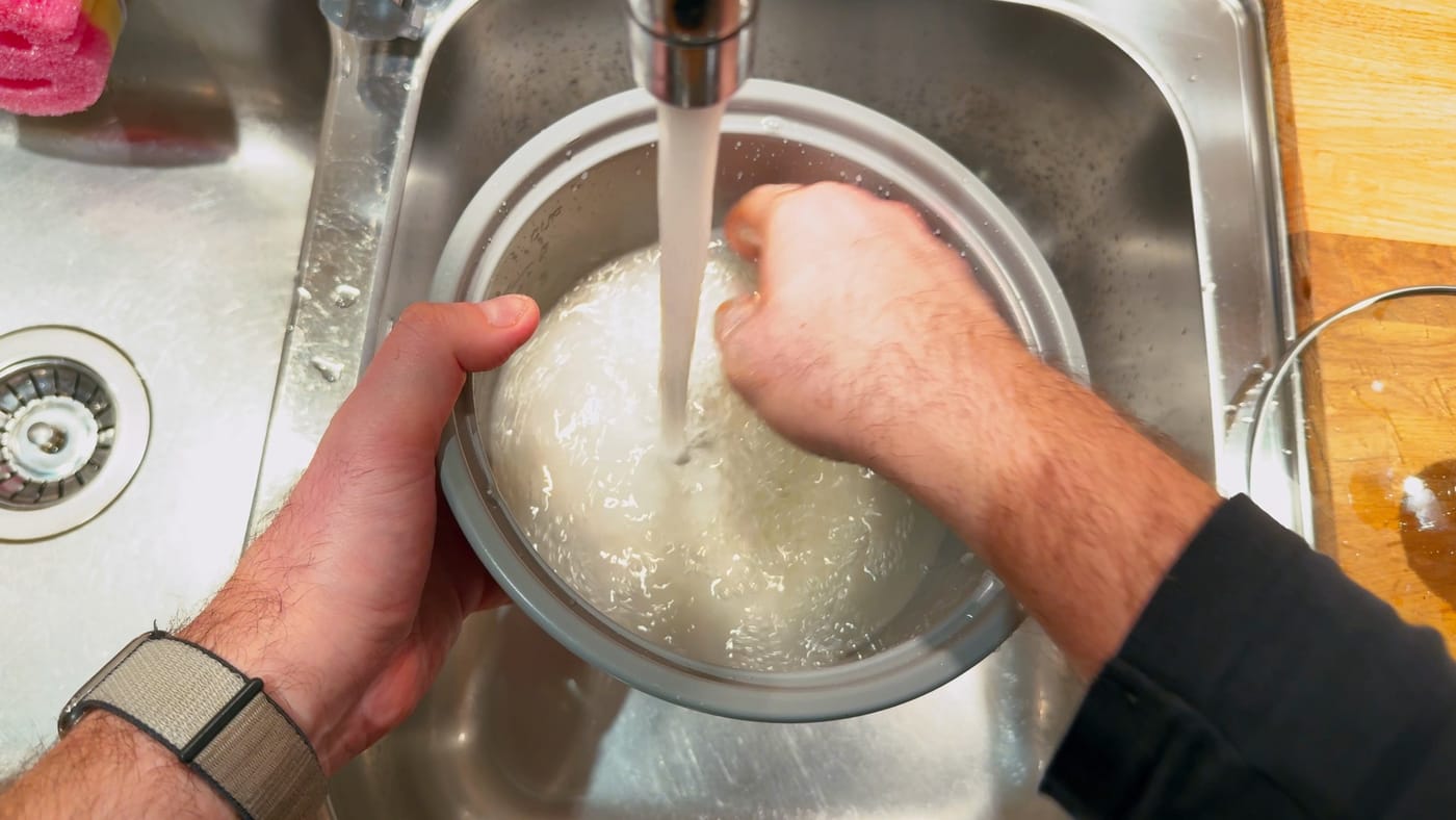 Rinsing the rice under the tap