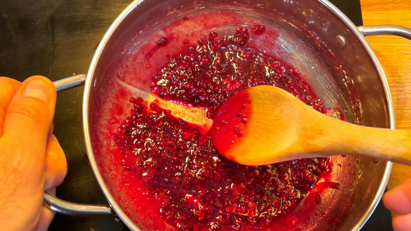 Raspberries cooking down into jam