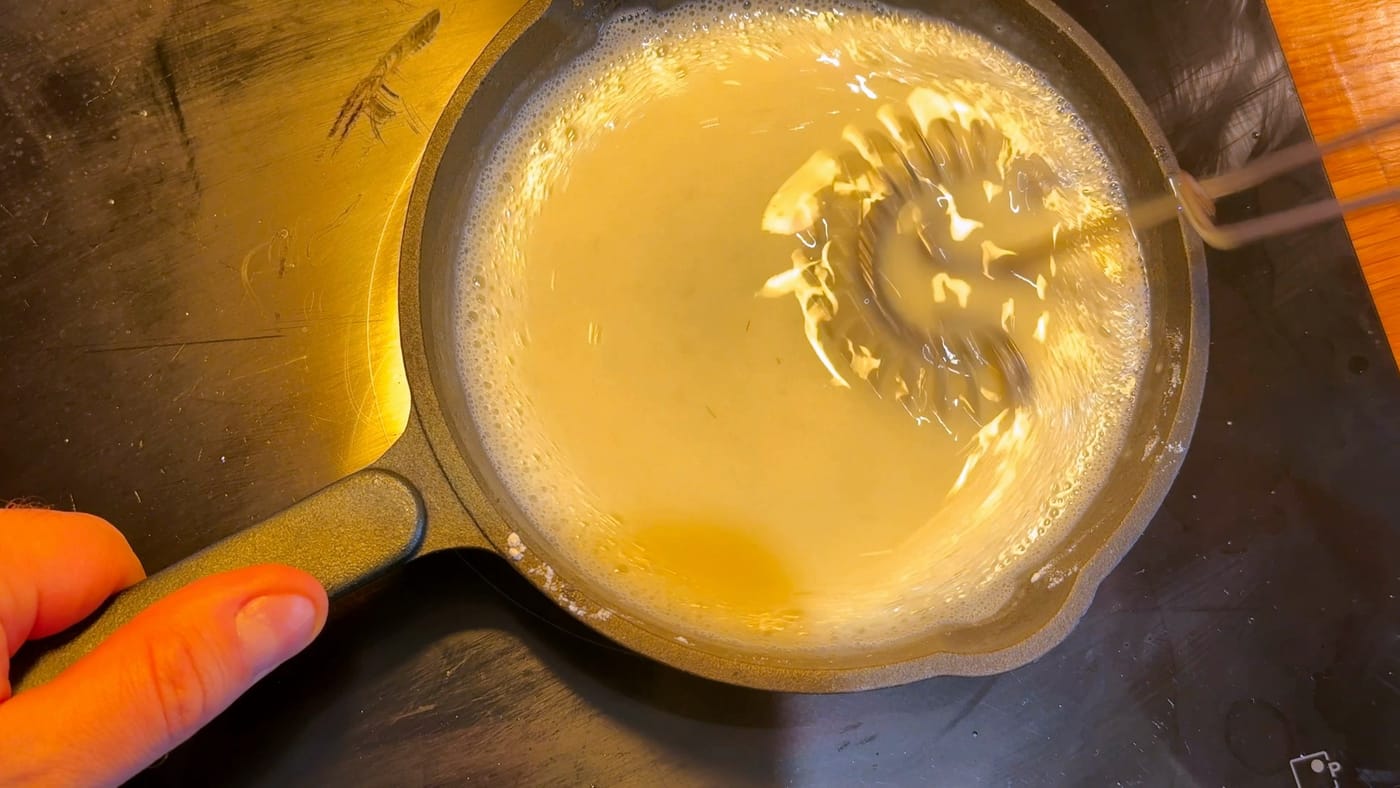 The milk pudding thickening in the pan